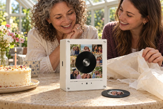Mother and adult daughter sharing a personalized photo music box at a birthday table